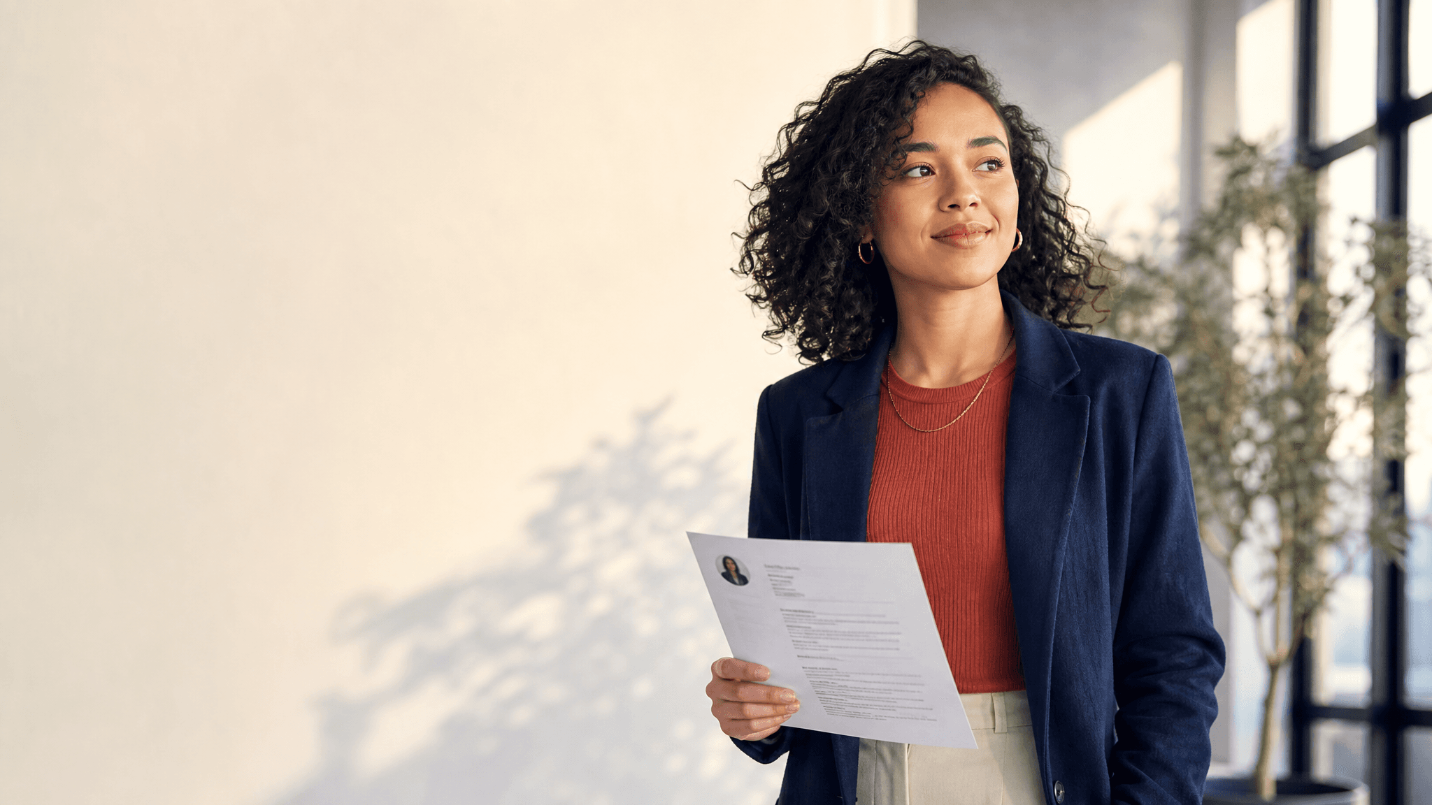 A confident job candidate holding a resume, ready for an interview